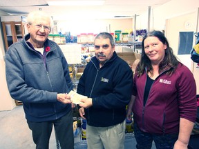Bearing a gift of more than $1,600 in cash for the Seaforth and District Food Bank, the Family Paradise Campground has done there good deed before Christmas. From the left are SDFB, committee chair, Bob McDowell, FPC managers, Mike and Cathy Mulholland.(Shaun Gregory/Huron Expositor)