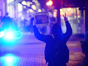 A protester gestures after a protest against US President-elect Donald Trump in Portland, Oregon on November 12, 2016. Trump huddled with advisers inside his Manhattan residence on November 12, plotting his next moves as thousands of demonstrators besieged Trump Tower and marched through other US cities in a fourth day of protests.  (ANKUR DHOLAKIA/AFP/Getty Images)
