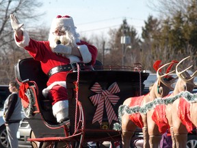 Santa Claus waves to the crowd during the Wallaceburg's Knights of Pythias Santa Claus parade on Saturday.