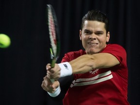 Canada's Milos Raonic returns against Japan's Kei Nishikori during a Davis Cup world group first-round singles match in Vancouver on March 8, 2015. (THE CANADIAN PRESS/Darryl Dyck)