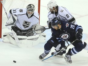 Los Angeles Kings defenceman Drew Doughty (centre) and Winnipeg Jets right-winger Blake Wheeler (right) fight for the puck in front of Kings goalie Peter Budaj during Sunday's game. (Brian Donogh/Winnipeg Sun)