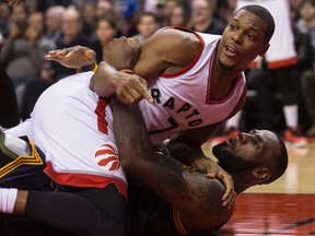 Toronto Raptors guard Kyle Lowry lands on Cleveland Cavaliers forward LeBron after Lowry got called for an offensive foul during NBA action in Toronto on Oct. 28, 2016. (THE CANADIAN PRESS/Chris Young)