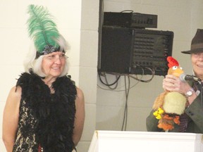 Deb Thorn, right, offers a demonstration on how to deal with citizens against virtually everything (CAVE) people at the Teeny Tiny Southwest Summit in Alvinston Tuesday. She and Yvette Moore, pictured left, dressed up as Al Capone and a flapper respectively as part of their presentation on how Capone's story helped their city of Moose Jaw, Sask. rebuild itself. (Barbara Simpson/Sarnia Observer)