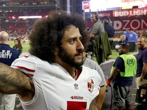 San Francisco 49ers quarterback Colin Kaepernick makes a fist as he is booed by fans after an NFL football game against the Arizona Cardinals, Sunday, Nov. 13, 2016, in Glendale, Ariz. (AP Photo/Ross D. Franklin)