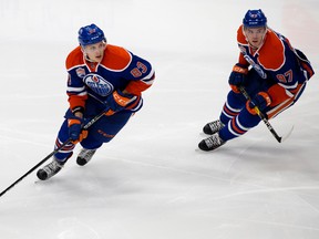 Matt Benning, shown here with Connor McDavid in Sunday's game at Rogers Place, follows his father's footsteps as a defenceman with the Oilers. (David Bloom)