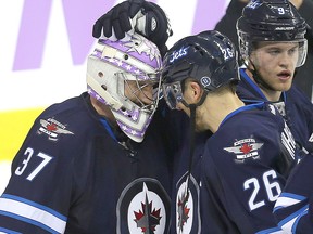 Winnipeg Jets goalie Connor Hellebuyck (l) is congratulated by right winger Blake Wheeler after shutting out the Chicago Black Hawks 4-0 during NHL hockey in Winnipeg, Man. Tuesday November 15, 2016. Brian Donogh/Winnipeg Sun/Postmedia Network