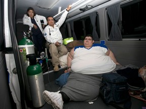 Juan Pedro is taken care of by paramedics on arrival at hospital in Guadalajara, Mexico, Tuesday, Nov. 15, 2016. Juan Pedro, who weighs about 1,100 pounds (500 kilos) and hasn't left his bed in six years has been removed by medical personnel for treatment. His doctor gave the man's name only as Juan Pedro, 32, from the central city of Aguascalientes. (AP Photo/Refugio Ruiz)