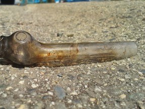 A dirty glass crack pipe lies in the gutter at the side of the road. (Getty Images)