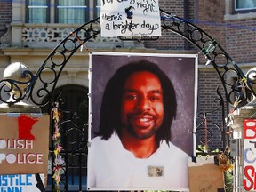 In this July 25, 2016, file photo, a memorial including a photo of Philando Castile adorns the gate to the governor's residence where protesters continue to demonstrate in St. Paul, Minn., against the July 6 shooting death of Castile by St. Anthony police officer Jeronimo Yanez during a traffic stop in Falcon Heights, Minn. Prosecutors announced Wednesday, Nov. 16, 2016, that Yanez has been charged with second-degree manslaughter in the killing. (AP Photo/Jim Mone, File)
