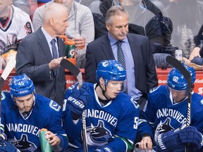 Vancouver Canucks' head coach Willie Desjardins stands on the bench behind players Michael Chaput, Brendan Gaunce and Markus Granlund during an NHL game against the New York Rangers in Vancouver on Nov. 15, 2016. (THE CANADIAN PRESS/Darryl Dyck)