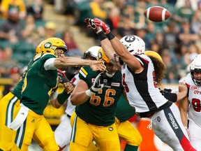 Eskimos quarterback Mike Reilly (left) throws past Redblacks defenders during CFL action in Edmonton on June 25, 2016. The Esks face the Redblacks in Ottawa in the CFL's Eastern Division final on Sunday. (Ian Kucerak/Postmedia/Files)