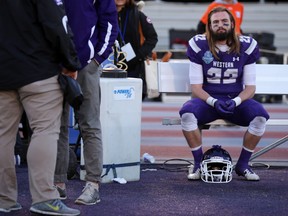 Western Mustangs running back Myles Rombough sits on the bench, staring out to the field, following their 43-40 loss to the Laurier Golden Hawks in the OUA Yates Cup football championship game at TD Stadium in London, Ont. on Saturday November 12, 2016. (CRAIG GLOVER, The London Free Press)