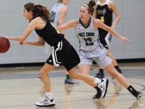 Holy Cross Crusaders' Mary Besselink defends La Salle Black Knights' Bryn Reynolds during the Kingston Area Secondary Schools Athletic Association senior girls basketball final at the Queen's Athletics and Recreation Centre on Monday night. (Julia McKay/The Whig-Standard)