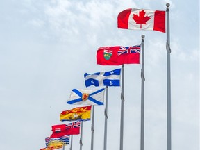 A Canadian flag along with the flags of the 10 Canadian provinces and the 3 Canadian territories are pictured in Ottawa in this undated file photo. (File photo)