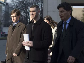 Adam Picard (centre) exits the Ottawa Courthouse with his lawyer Lawrence Greenspon (R) in 2016. (Errol McGihon)