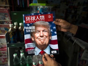 A copy of the local Chinese magazine Global People with a cover story that translates to "Why did Trump win" is seen with a front cover portrait of U.S. president-elect Donald Trump at a news stand in Shanghai on November 14, 2016. (JOHANNES EISELE/AFP/Getty Images)