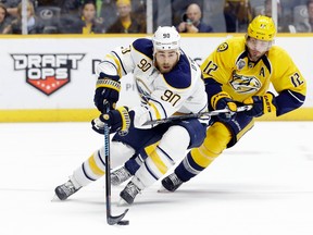 Buffalo Sabres centre Ryan O'Reilly (90) is defended by Nashville Predators' Mike Fisher on Nov. 28 (AP Photo/Mark Humphrey).