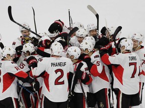 Senators players celebrate with Erik Karlsson (65) after he scored the game-winning goal during the shootout against the Flyers in Philadelphia on Tuesday, Nov. 15, 2016. (Matt Slocum/AP Photo)