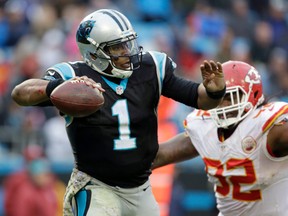 Panthers quarterback Cam Newton (left) looks to pass under pressure from Chiefs' Dontari Poe (92) during NFL action in Charlotte, N.C., on Sunday, Nov. 13, 2016. (Bob Leverone/AP Photo)