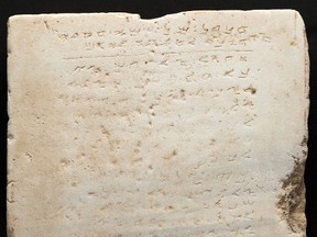 This undated photo provided by Heritage Auctions, HA.com shows the world's earliest-known stone inscription of the Ten Commandments – a two-foot square slab of white marble, weighing about 115 pounds and inscribed in an early Hebrew script called Samaritan, that sold for $850,000 Wednesday evening, Nov. 16, 2016, at a public auction of ancient Biblical archaeology artifacts held by Heritage Auctions in Beverly Hills, Calif. (Matt Roppolo/Heritage Auctions, HA.com via AP)