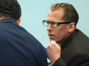 Steven Dean Gordon, right, leans over to talk to his court-appointed investigator during opening statements in his trial Wednesday, Nov. 16, 2016, at Orange County Superior Court in Santa Ana. Calif. Gordon, 47, a sex offender accused of raping and killing four women while he wore an electronic monitoring device during a months-long rampage in Southern California, is acting as his own attorney during opening statements. (Sam Gangwer/The Orange County Register via AP)
