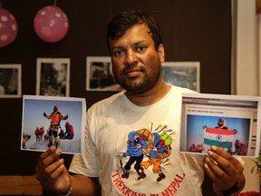 In this July 4, 2016 file photo, Indian climber, Satyarup Sidhantha holds on his right hand a photograph that shows him on Mount Everest, along with what he says is an altered version of the same used by an Indian couple to make it appear they were on the summit, as he displays them for the Associated Press in Kolkata, India.Two police officers — a husband and wife — have been suspended in India for falsely claiming they scaled Mount Everest in Nepal in May, police said Thursday. Nepal's government earlier canceled the climbing certificates issued to Dinesh Rathod and Tarkeshwari Rathod after it found they had presented a fake photograph of themselves on Everest's summit. (AP Photo/ Bikas Das, File)