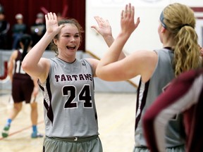Wallaceburg Tartans' Kaitlyn Quinlan (24) high-fives Brett Fischer after beating the McGregor Panthers 53-23 in the LKSSAA 'AA' senior girls basketball final at Wallaceburg District Secondary School in Wallaceburg, Ont., on Saturday, Nov. 12