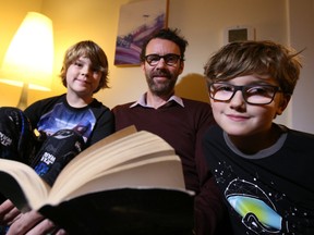 Oscar Alexander-Ramsay, left, Denny Alexander and Dominic Alexander-Ramsay read before going to bed.