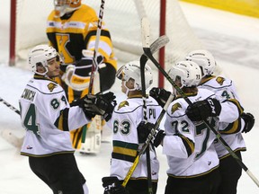 Sam Miletic #48 of the Knights is congratulated by JJ Piccinich, Cliff Pu, and Janne Kuuokkanen after he scored in the first period of their game at Budweiser Gardens in London, Ont. on Friday November 11, 2016. (MIKE HENSEN, The London Free Press)