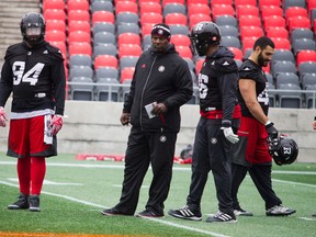 Redblacks defensive lineman Cleyon Laing (left) and teammates at practice on Nov. 17. (Ashley Fraser, Postmedia Network)