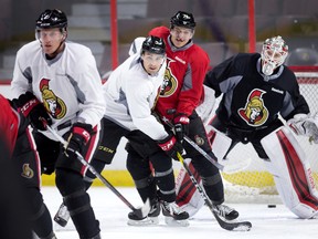 Senators goalie Andrew Hammond (right) is No. 3 on the depth chart, but he feels he’s better off practising in Ottawa than getting game action in Binghamton. (WAYNE CUDDINGTON/Postmedia Network)