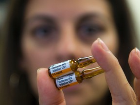 Shaya Dhinsa, a manager at Middlesex-London Heath Unit, holds ampoules of naloxone, a medication that reverses the fatal effects of an opioid overdose by restoring respiration. The health unit wants anyone prescribed an opioid to be given access to and counselling on the drug. (MIKE HENSEN, The London Free Press)