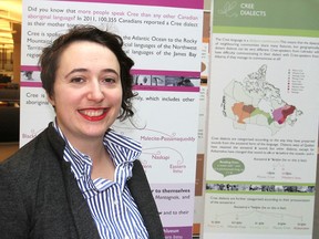 Queen's University's Dr. Bronwyn Bjorkman stands in front of a display on indigenous languages currently at the campus library in Kingston on Thursday, which details their grammar, varieties and current status. (Michael Lea/The Whig-Standard)