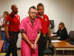 In this Nov. 4, 2016, file photo, Scott Michael Greene, accused of murdering two police officers, is brought in for his initial court appearance at the Polk County Jail in Des Moines, Iowa. Greene has been charged in the ambush-style attacks of Des Moines Sgt. Anthony Beminio and Urbandale officer Justin Martin. Days before he allegedly killed the two officers, Greene sent a note to one of their departments apologizing for prior run-ins, saying his "dark days" were over and declaring that police were "absolute heroes." (Bryon Houlgrave/The Des Moines Register via AP, File) /The Des Moines Register via AP )