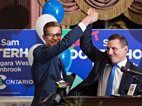 Progressive Conservative candidate Sam Oosterhoff, left, and Ontario PC leader Patrick Brown, celebrate Oosterhoff, 19, winning the byelection in Niagara-West Glanbrook, becoming Ontario's youngest-ever MPP, on Nov 17, 2016 in Grimsby. (THE CANADIAN PRESS/Aaron Lynett)