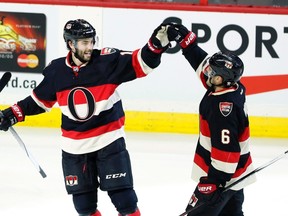 Senators’ Derick Brassard (left) celebrates his power-play goal with Chris Wideman last night against the Predators. (THE CANADIAN PRESS)