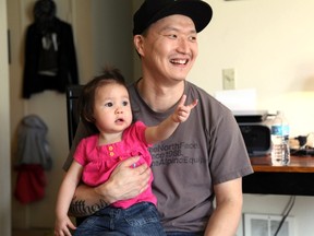 In this March 19, 2015, file photo, Korean adoptee Adam Crapser poses with daughter, Christal in the family's living room in Vancouver, Wash. The immigration attorney for Crapser, who was adopted from South Korea almost four decades ago and flown to America, says he has been deported. U.S. Immigration and Customs Enforcement ordered Adam Crapser be deported because of criminal convictions including assault and being a felon in possession of a weapon. (AP Photo/Gosia Wozniacka, File)