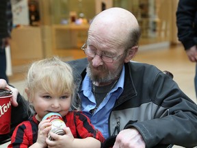 Payton Burton, 3, and her grandfather, Roger Burton, older brother of the late Edgar Burton, attended the launch of the Edgar Burton Christmas Food Drive and Kids Helping Kids campaign at the New Sudbury Centre in Sudbury on Thursday. John Lappa/Sudbury Star