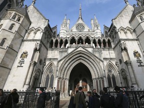 In this Thursday Nov. 3, 2016 file photo media gather outside the High Court in London. High Court Judge Peter Jackson has granted the final wishes of a 14-year-old girl to be cryogenically preserved, in what he called the first case of its kind in England — and possibly the world. (AP Photo/Tim Ireland, File)