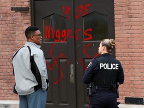Hate graffiti on Parkdale United Church in Ottawa , November 18, 2016.  Photo by Jean Levac  ORG XMIT: 125374
Reverend Dr. Anthony Bailey with police officer.
Jean Levac