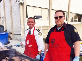 Dean Dunne, superintendent at Sarnia Jail, and Joel Bissonnette, OPSEU local 128 president at Sarnia Jail, barbecue burgers for the staff and employees at both the Sarnia Jail, and the courthouse in Sarnia. The barbecue kicked off the United Way pledge drive at the Sarnia Jail. United Way photo
