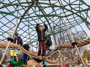 Youngsters enjoys one of the play structures now open to the public as the city quietly opens the controversial Giver 150 Mooney’s Bay playground.