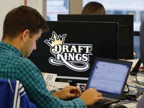 In this Sept. 9, 2015, file photo, Bear Duker, a marketing manager for strategic partnerships at DraftKings, works at his computer at the company headquarters in Boston. (AP Photo/Stephan Savoia, File)