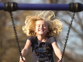 Julie-Marie Gentile, 8, a grade 3 pupil at Victoria Public School takes a full swing at enjoying the summer-like weather in London, Ont. on Friday November 18, 2016. Gentile was in Greenway Park with her mom Nancy, a half dozen aunts and tons of cousins enjoying a PD day off school. Mom Nancy Gentile said, "this could be our last nice day, and the kids wanted to get out of the house."  (MIKE HENSEN, The London Free Press)