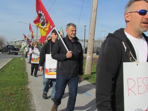 Approximately 30 members of the Public Service Alliance of Canada, as well as supporters from other unions, march during a rally on Friday November 18, 2016 outside the Blue Water Bridge Corporate Centre in Point Edward, Ont. The union represents 47 workers at the bridge who have been without a contract for two years. A bargaining session is scheduled for Saturday between the union and the Federal Bridge Corporation. (Paul Morden/Sarnia Observer)