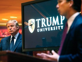In this May 23, 2005 file photo, then real estate mogul and reality TV star Donald Trump, left, listens as Michael Sexton introduces him at a news conference in New York where he announced the establishment of Trump University. (AP Photo/Bebeto Matthews, File)