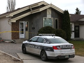 A police vehicle sits in the driveway on Pinetree Crescent in the Riverbend area on Thursday. (Kevin King/Winnipeg Sun)