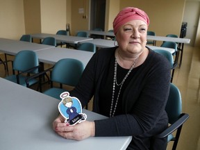 Luke Hendry/The Intelligencer
Joanne Callaghan, who's in her second battle with cancer, holds a paper angel at Belleville General Hospital Wednesday in Belleville. The BGH Foundation is selling the angels to raise funds for cancer care.