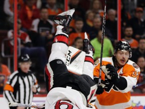 Senators’ Bobby Ryan (left) collides with Philadelphia Flyers’ Steve Mason during Tuesday’s game in Philadelphia. (AP)