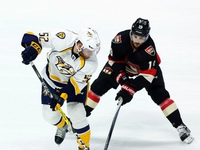 Nashville Predators’ Matt Irwin (left) and Senators’ Derick Brassard fight for the puck during Thursday’s game. Brassard broke a 15-game goal-scoring drought with his second tally of the season. (THE CANADIAN PRESS/PHOTO)